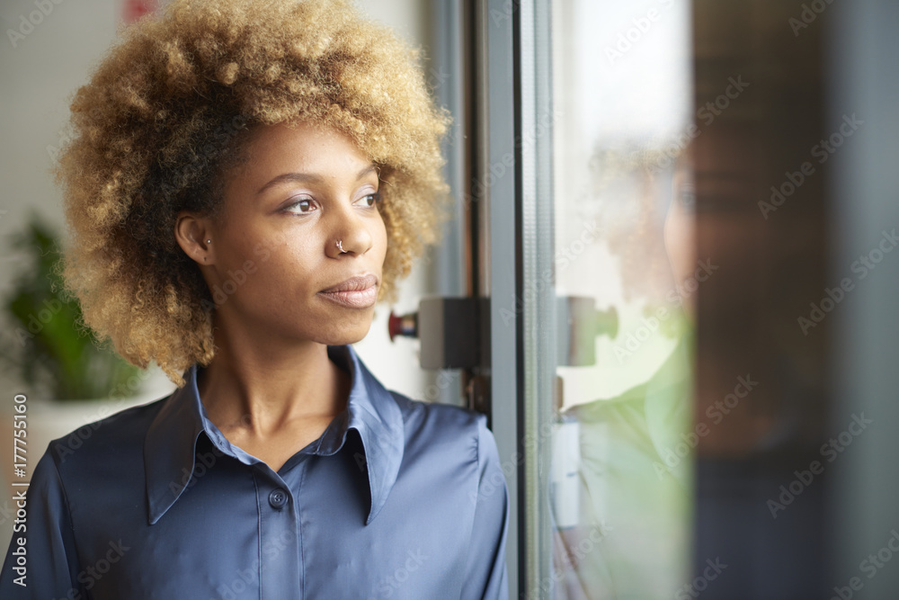 Samolepka Laughing young afro-american woman standing at window at home