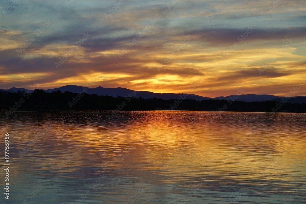 Dramatic orange sunset of the Lake Burley Griffin in Canberra, ACT, Australia