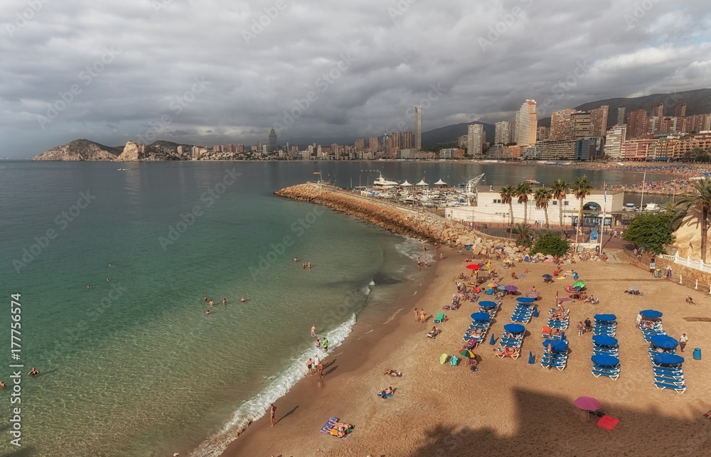 Editorial Benidorm, Spain - October 8, 2017: Holiday makers on the smallest beach in Benidorm, Mal Pas Beach, at the Spanish holiday resort of Benidorm on the eastern coast of Spain