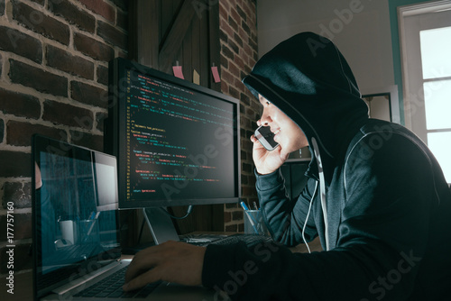 Fotótapéta hacker using mobile smartphone calling for victim
