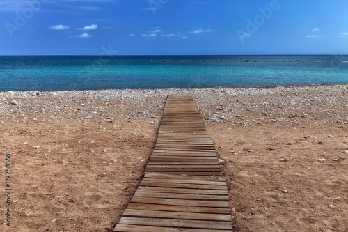 A boarded path or wooden boardwalk allowing easy access to and from the sea at Altea in Spain's Costa Blanca