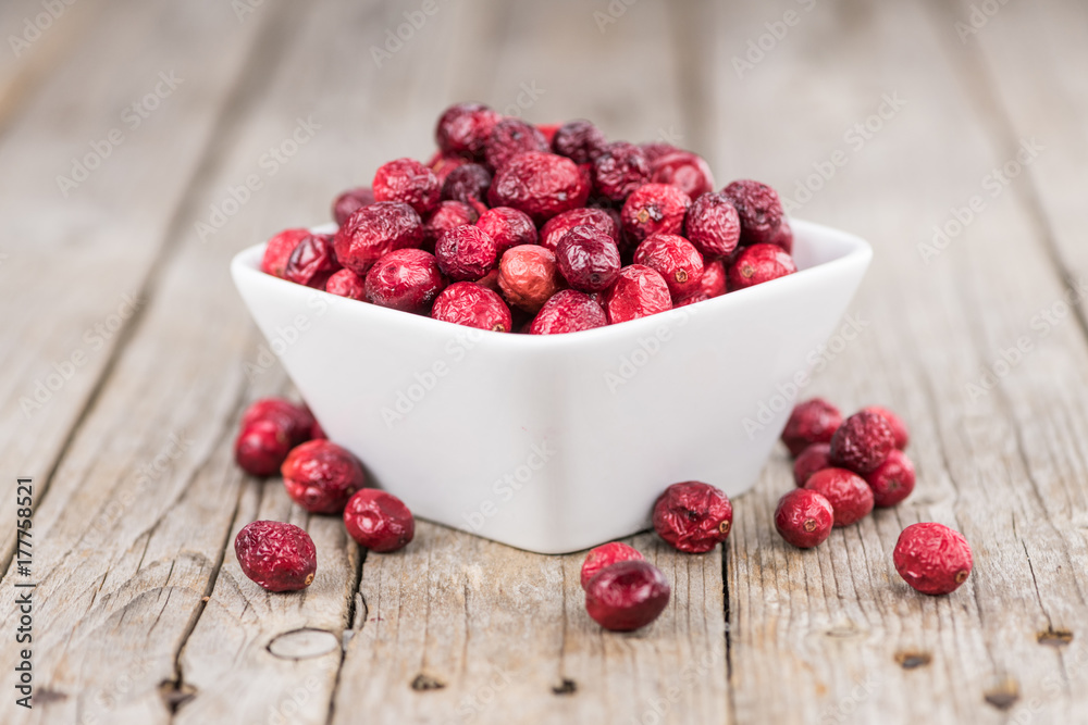 Some fresh Dried Cranberries on wooden background (selective focus; close-up shot) Some fresh Dried Cranberries on wooden background (selective focus; close-up shot)