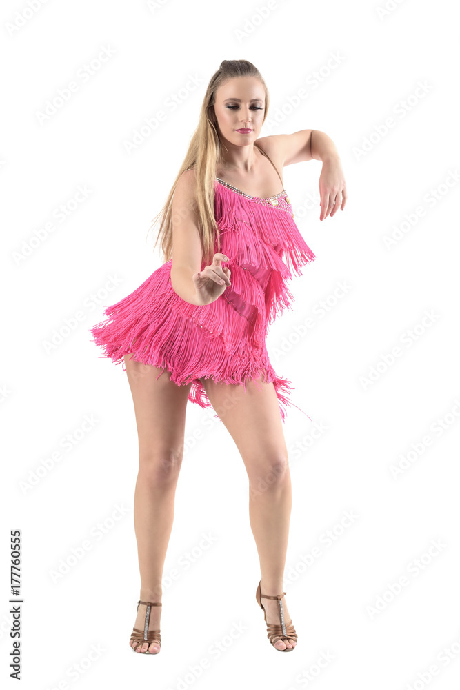 Elegant blonde woman in pink dress dancing rumba looking down. Full body length portrait isolated on white studio background. Elegant blonde woman in pink dress dancing rumba looking down. Full body length portrait isolated on white studio background.