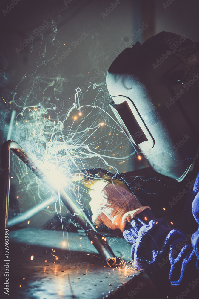 Welding steel pipe and producing sparks.