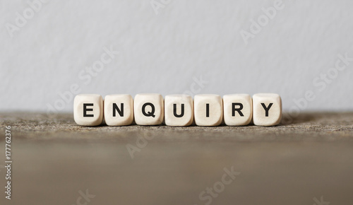 Word ENQUIRY made with wood building blocks
