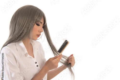 Portrait of asian woman long hair with a comb and problem hair on white background, Free form copy space.This image for hair loss concept. Free from copy space.