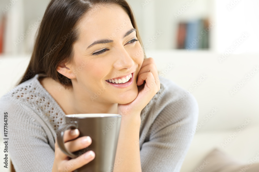 Happy woman holding a cup of coffee Happy woman holding a cup of coffee