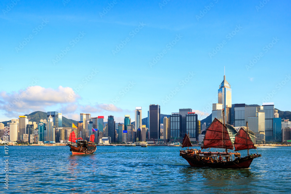 Hong Kong skyline cityscape, Tourist junk boat at Victoria Harbor in evening