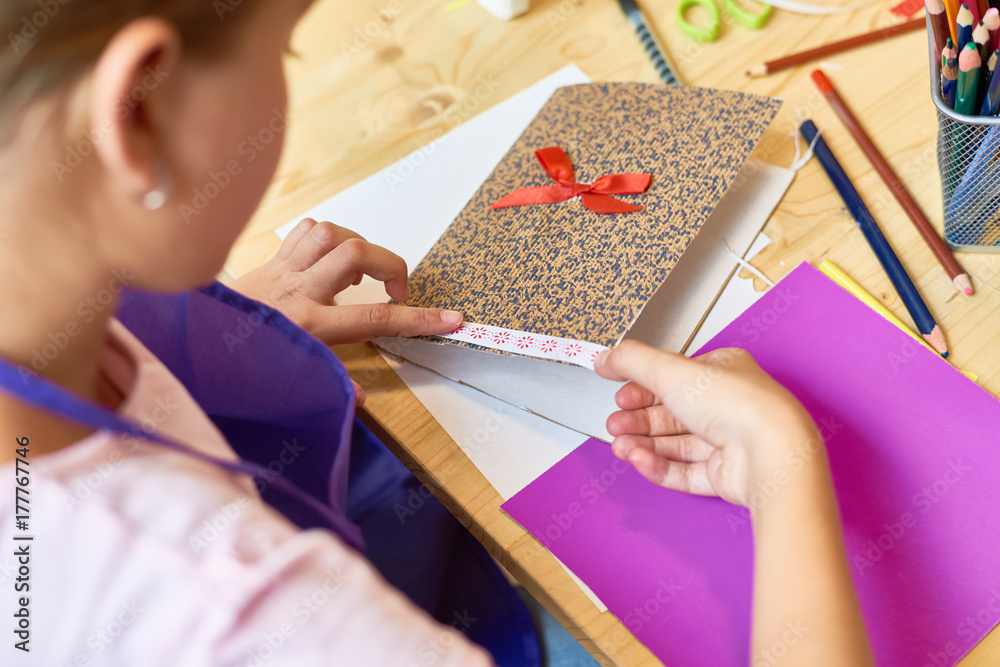 Φωτογραφία High angle closeup of teenage girl decorating beautiful handmade gift card durin
