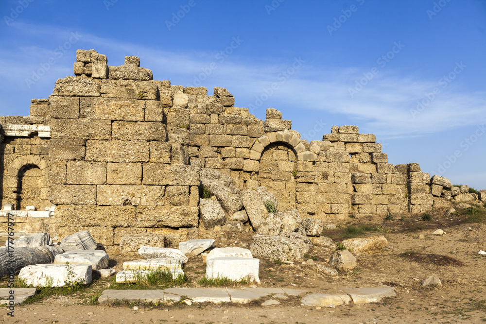The old ruined walls of the ancient city . Beautiful background with ancient ruins and Sunny summer day.