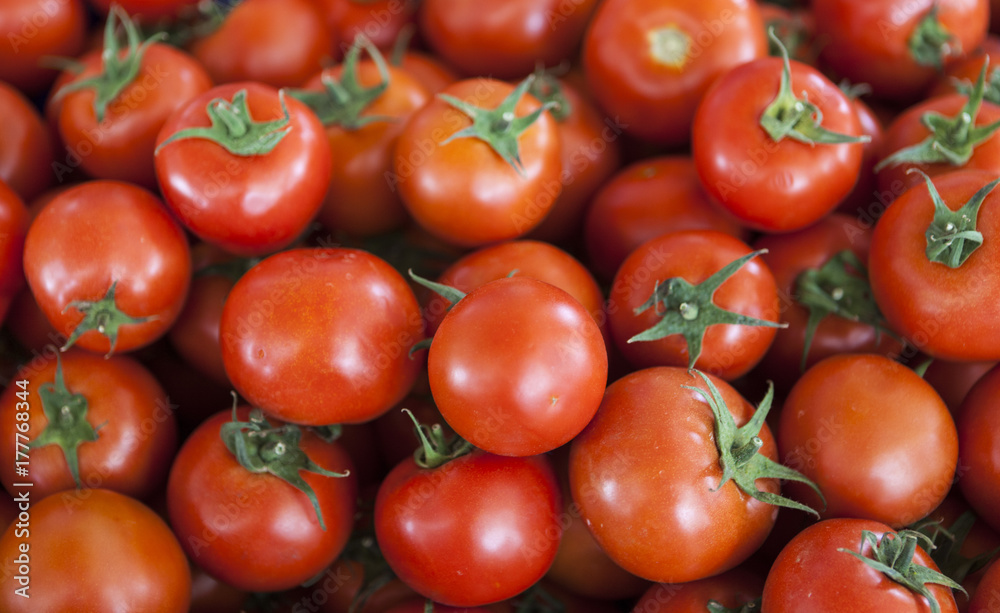 Qualitative background from tomatoes. Fresh tomatoes. Red tomatoes. Village market organic tomatoes.