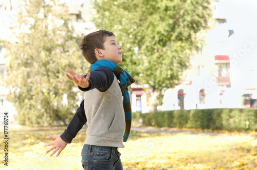 Boy running across the yard from the joyful feeling of freedom