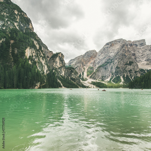 Lago di Braies or Pragser Wildsee in Fanes-Sennes-Braies Nature Park, square crop. Mountain lake with clear emerald waters in Valle di Braies in the Dolomite Alps in North Italy on gloomy day photo
