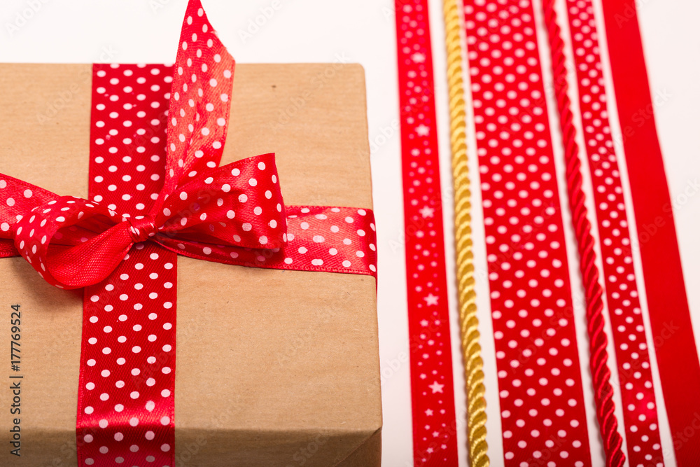 Obraz premium Christmas gifts ribbon colors red and golden ribbons motives, polka dot and stars golden twisted strings, white background, new year celebration gifts packs decoration ribbons