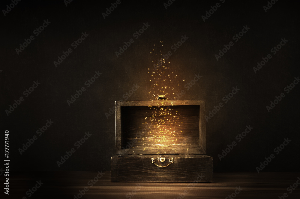 Obraz premium Otwarta skrzynia skarbów z świecącymi błyskami i gwiazdami