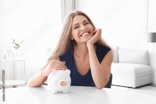 Young woman with piggy bank...