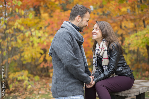 Young couple in love in a park on a autumn day