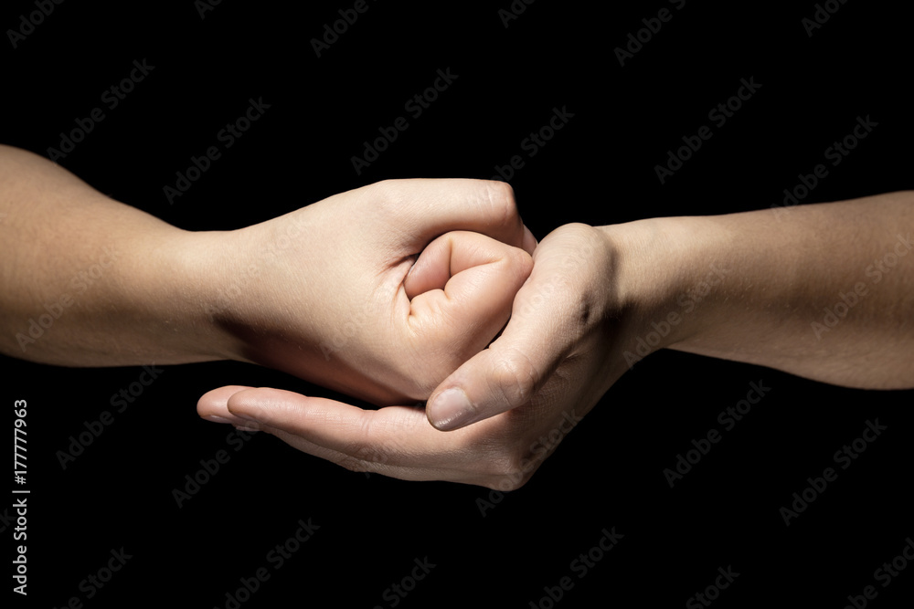 hands in mudra gesture on black background