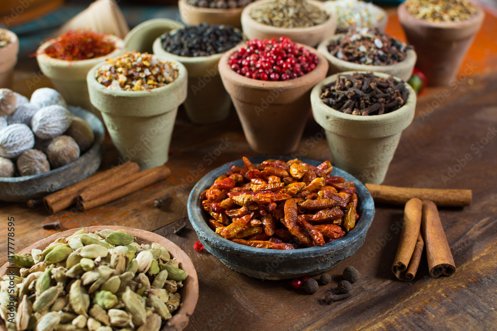 Variety of different asian and middle east spices, colorful assortment, on old wooden table