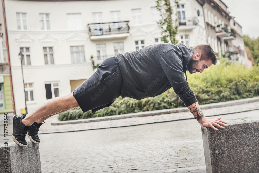 Athletic man training on a street.