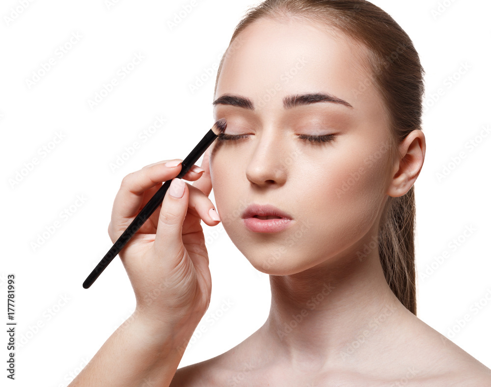 Applying female makeup, isolated on white