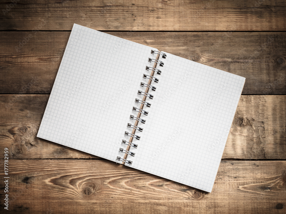Blank paper notebook on brown wooden table background. Top view Blank paper notebook on brown wooden table background. Top view