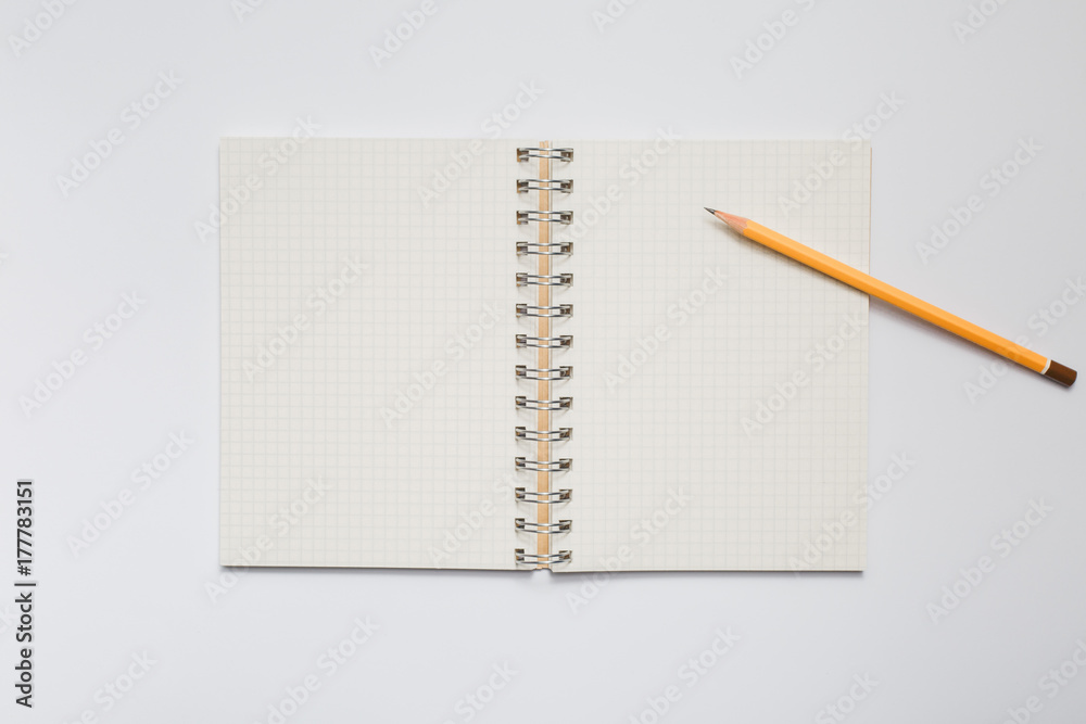 School notebook with yellow pencil School notebook with yellow pencil