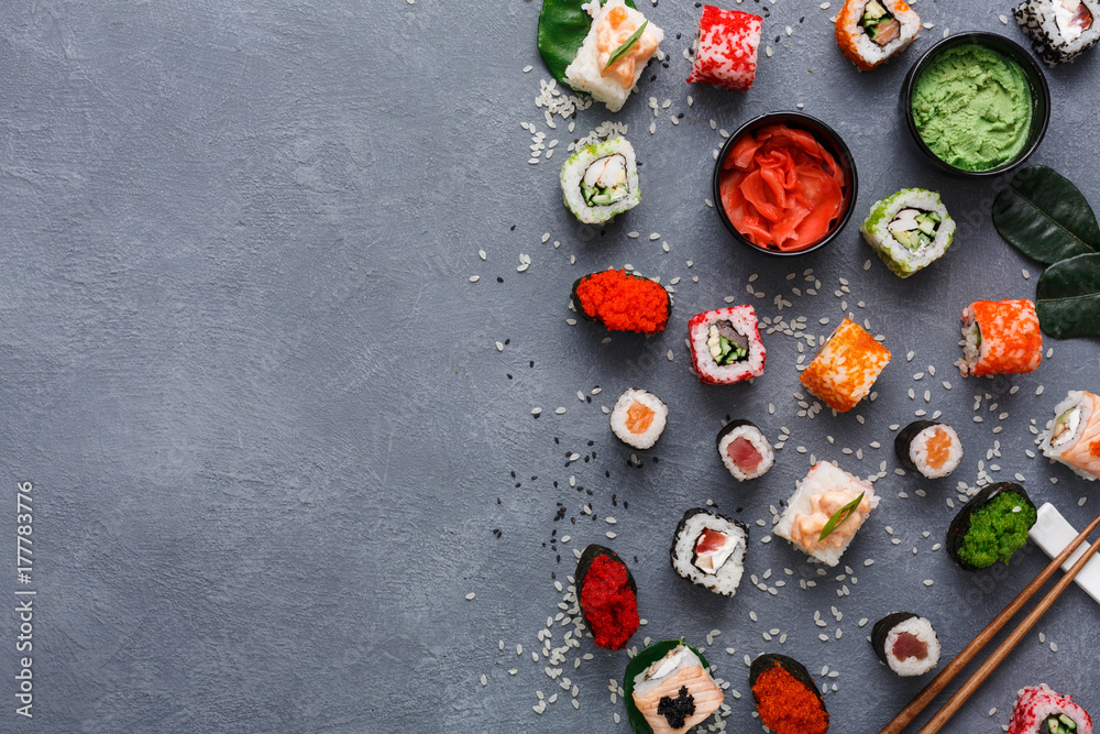 Top view set of sushi roll and gunkan on rustic grey and rice background