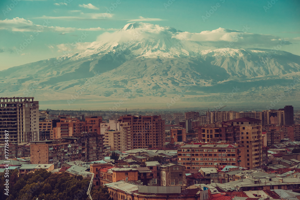 Inspirational mountain view. Yerevan cityscape. Travel to Armenia. Tourism industry. Mount Ararat on background. Armenian architecture. City tour. Urban landscape. Street view. Sightseeing concept.