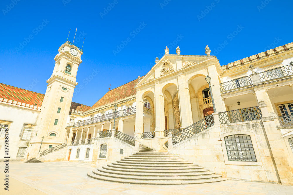 Popular and iconic University Clock Tower in the Paco das Escolas in blue sky. The University of Coimbra is the most ancient of Portugal and also one of the oldest in Europe.