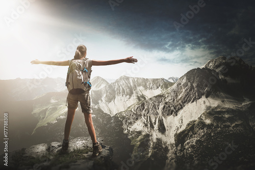 Mountain climber standing on a summit