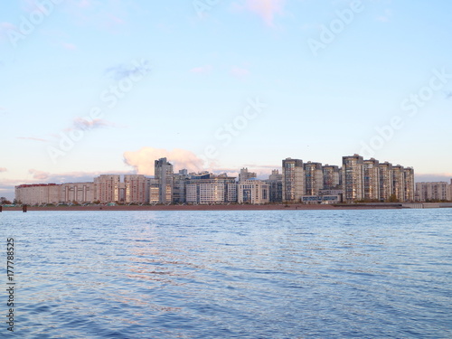 Urban blocks high-rise buildings on the beach at sunset © Andrey