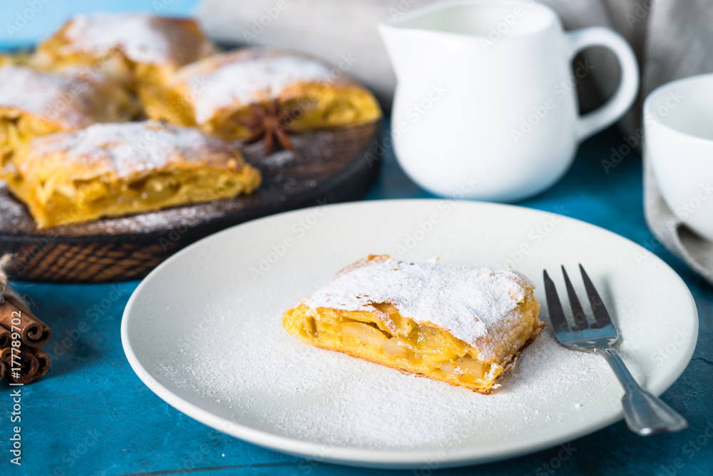 Apple strudel pie. Puff pastry on blue. Apple strudel pie. Puff pastry on blue.