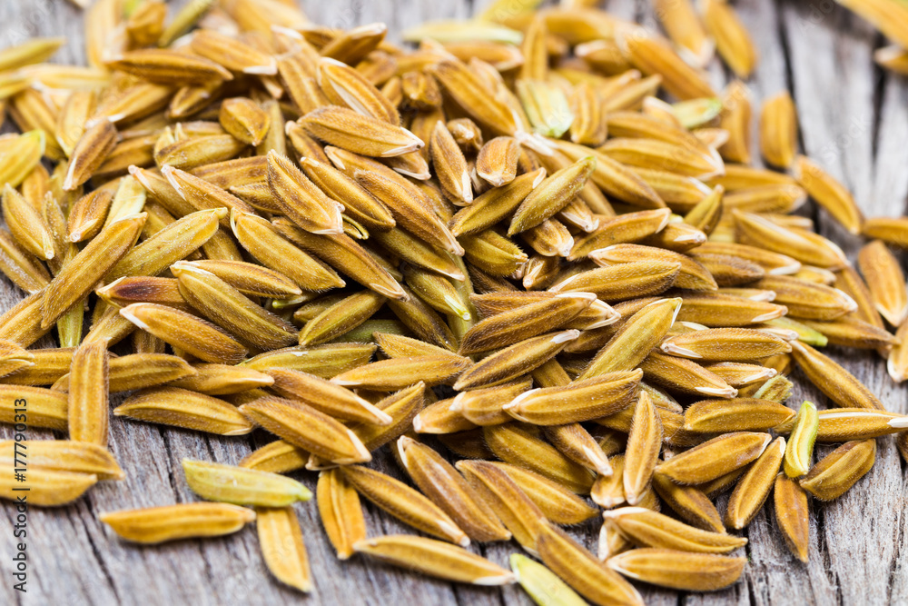 Close up macro rice grain on wooden background Close up macro rice grain on wooden background