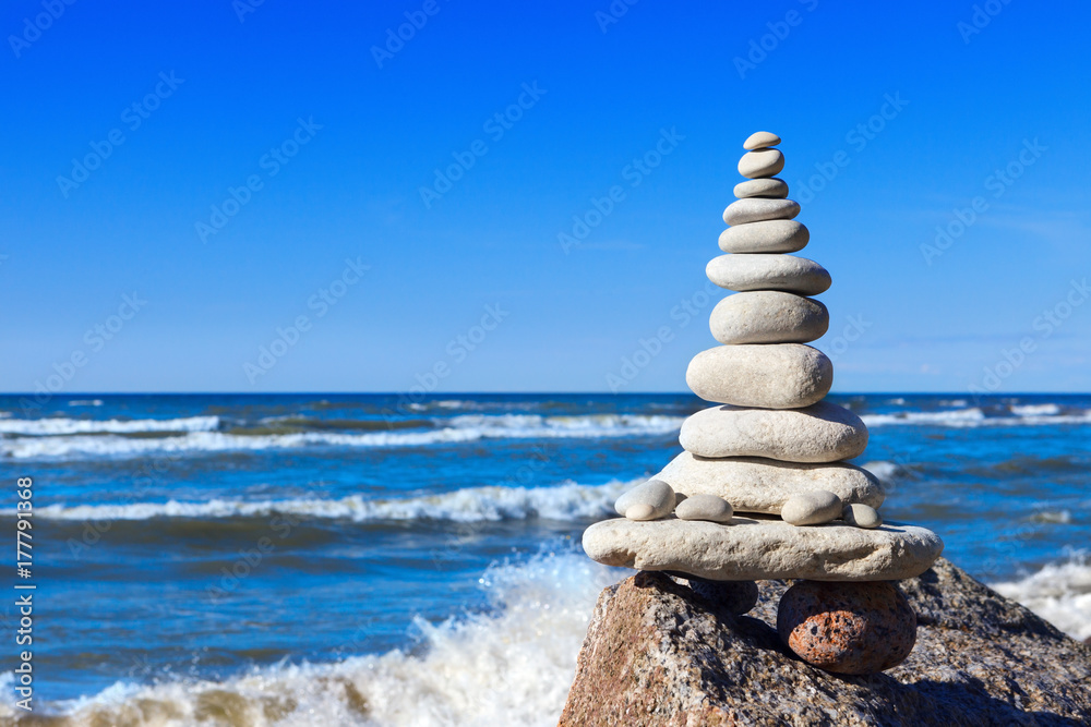Fototapeta premium Concept of balance and harmony. White rocks zen on the background of sea and blue sky