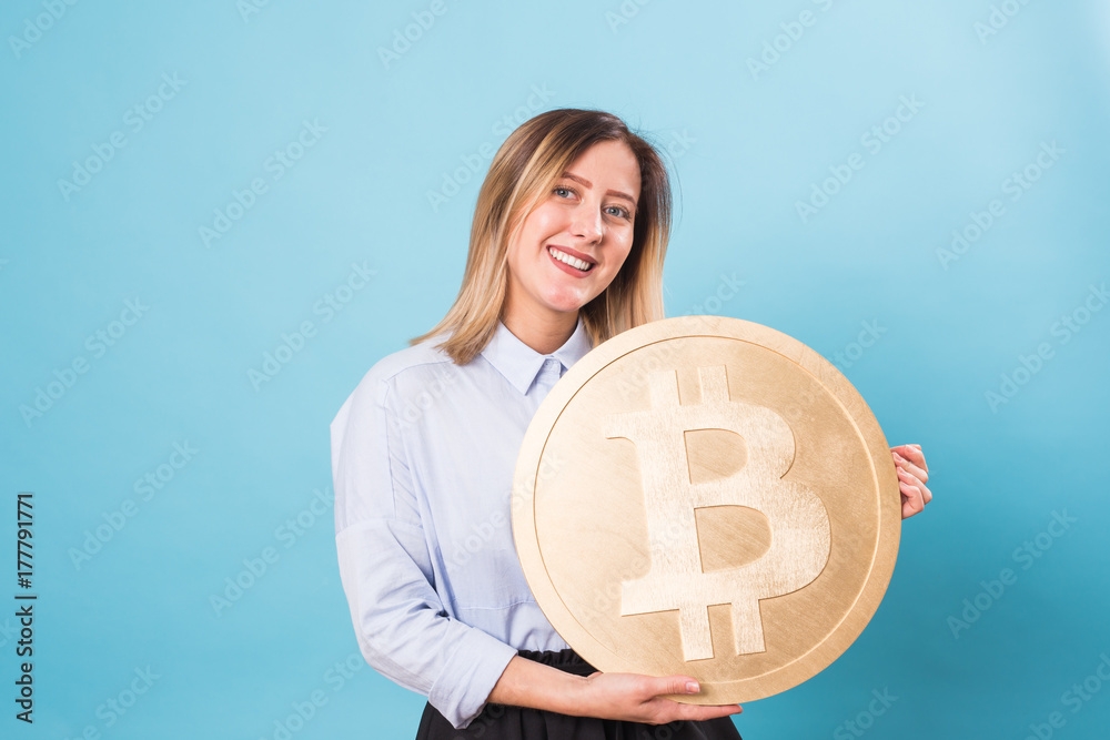 Funny woman holding a Golden Bitcoin. virtual money. Funny woman holding a Golden Bitcoin. virtual money.