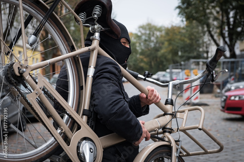 Wallpaper Mural Theft wearing a balaclava stealing a bicycle