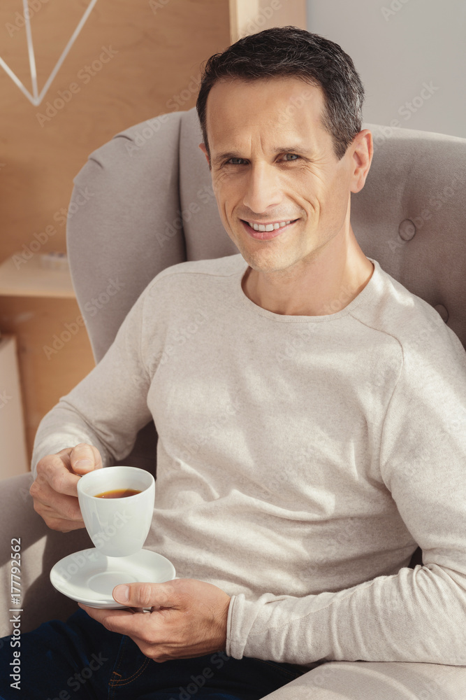 Relaxed man going to drink coffee