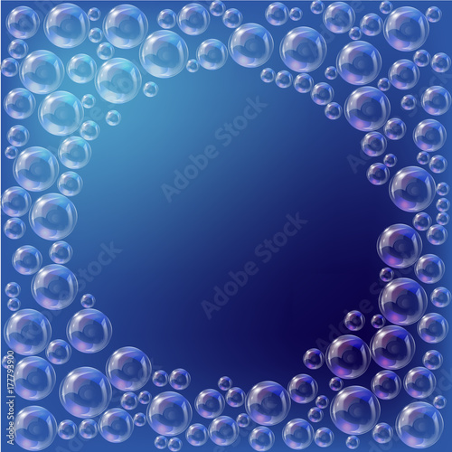 Round frame of transparent soap bubbles on a blue background