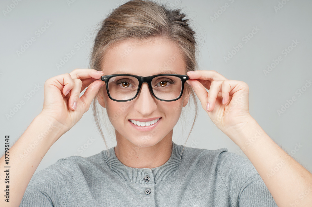 Young woman checking new eyeglasses Young woman checking new eyeglasses