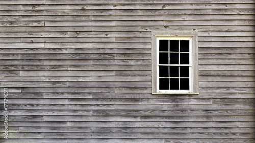 background of a rustic exterior wall of wooden planks and a window