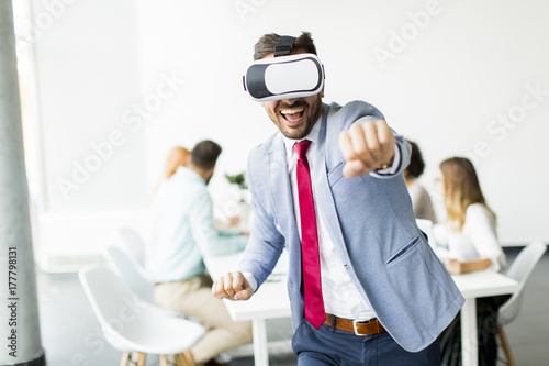Modern businessman with virtual reality headsets in the office