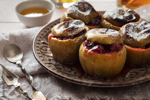Baked apples with sugar powder and cranberries