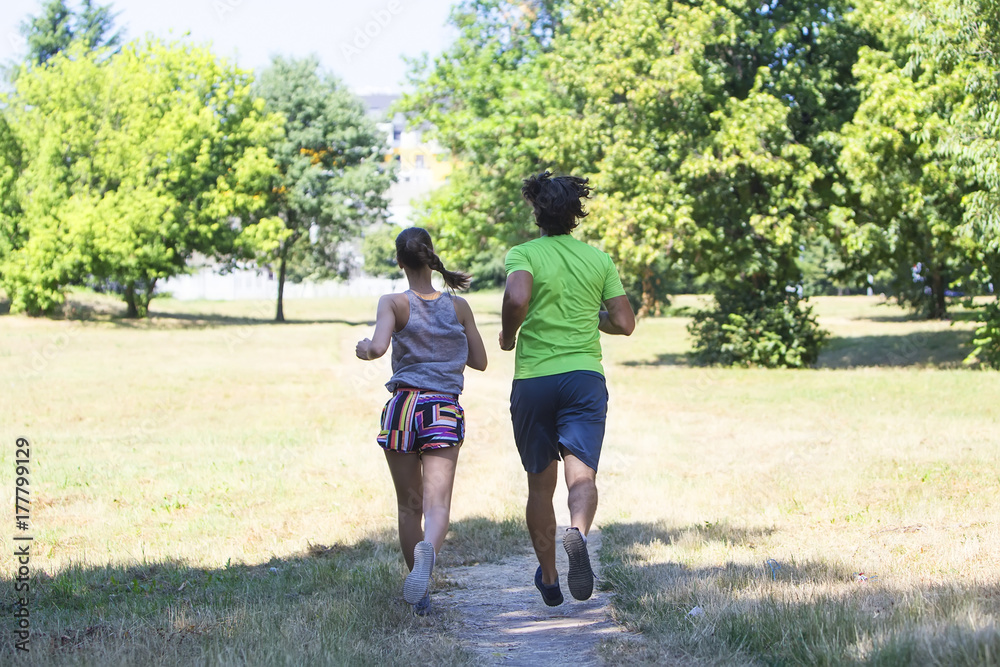 Healthy, fit and sportive couple running in park Healthy, fit and sportive couple running in park