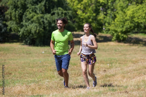 Healthy, fit and  sportive couple running in park