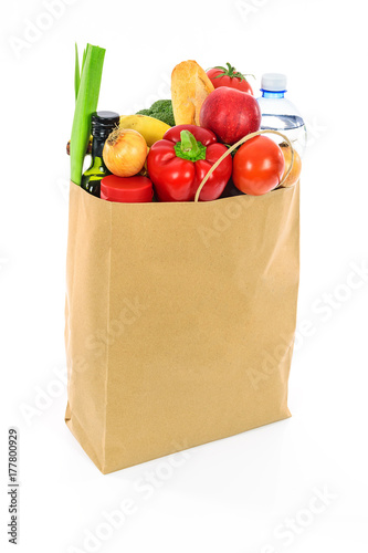 Grocery shopping concept image - Eco friendly paper shopping bag filled with various food products.
