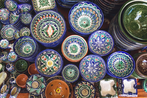 Ethnic Uzbek ceramic tableware. Decorative ceramic plates and cups with traditional uzbekistan ornament.