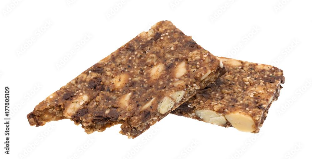 A broken almond butter chocolate nut bar isolated on a white background.