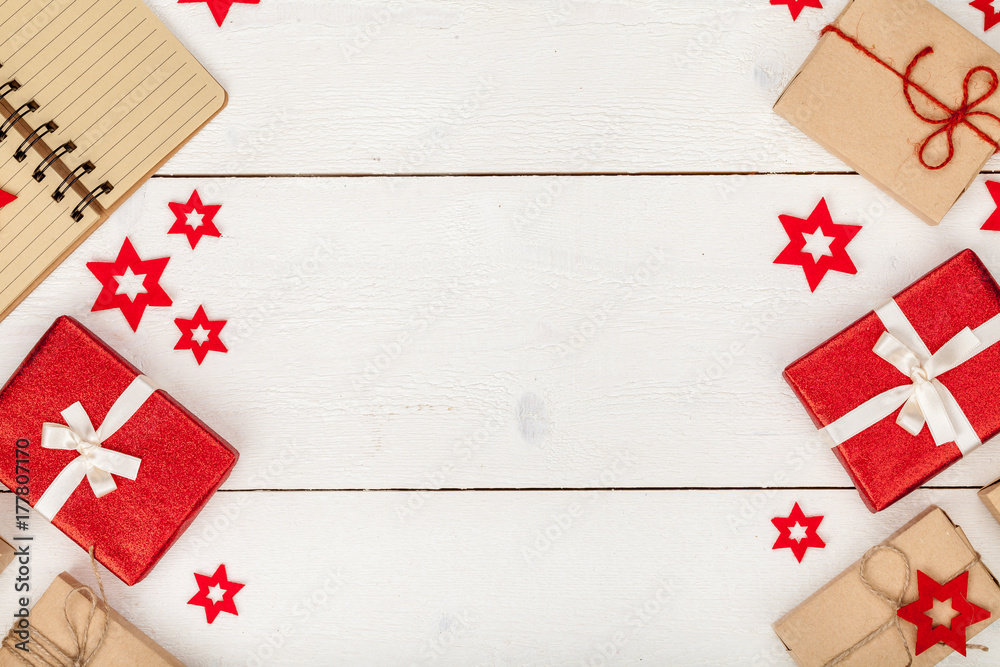 frame made of homemade wrapped christmas and new year present boxes and decoration on wooden background with copy space for text. holiday and celebration concept. above view, flat lay. frame made of homemade wrapped christmas and new year present boxes and decoration on wooden background with copy space for text. holiday and celebration concept. above view, flat lay.