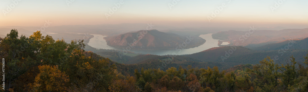 view of Danube curve from Pilis mountain in october autumn landscape, misty sunset